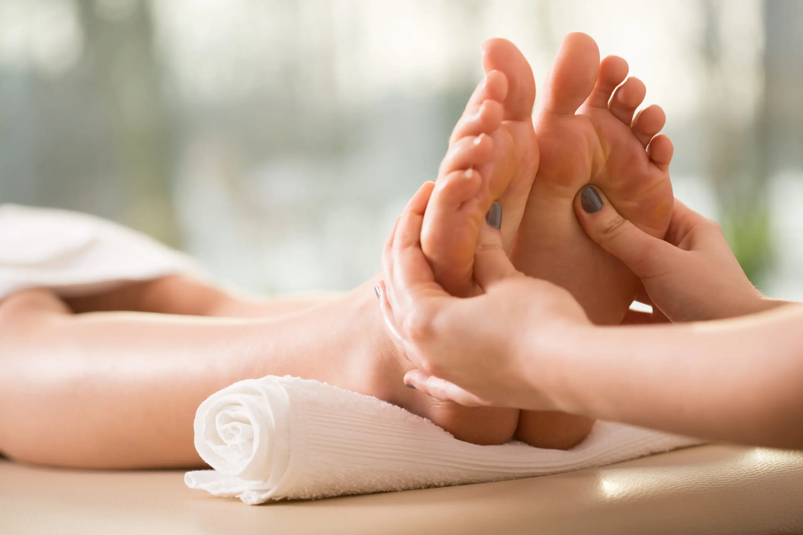 A person is getting their feet massaged