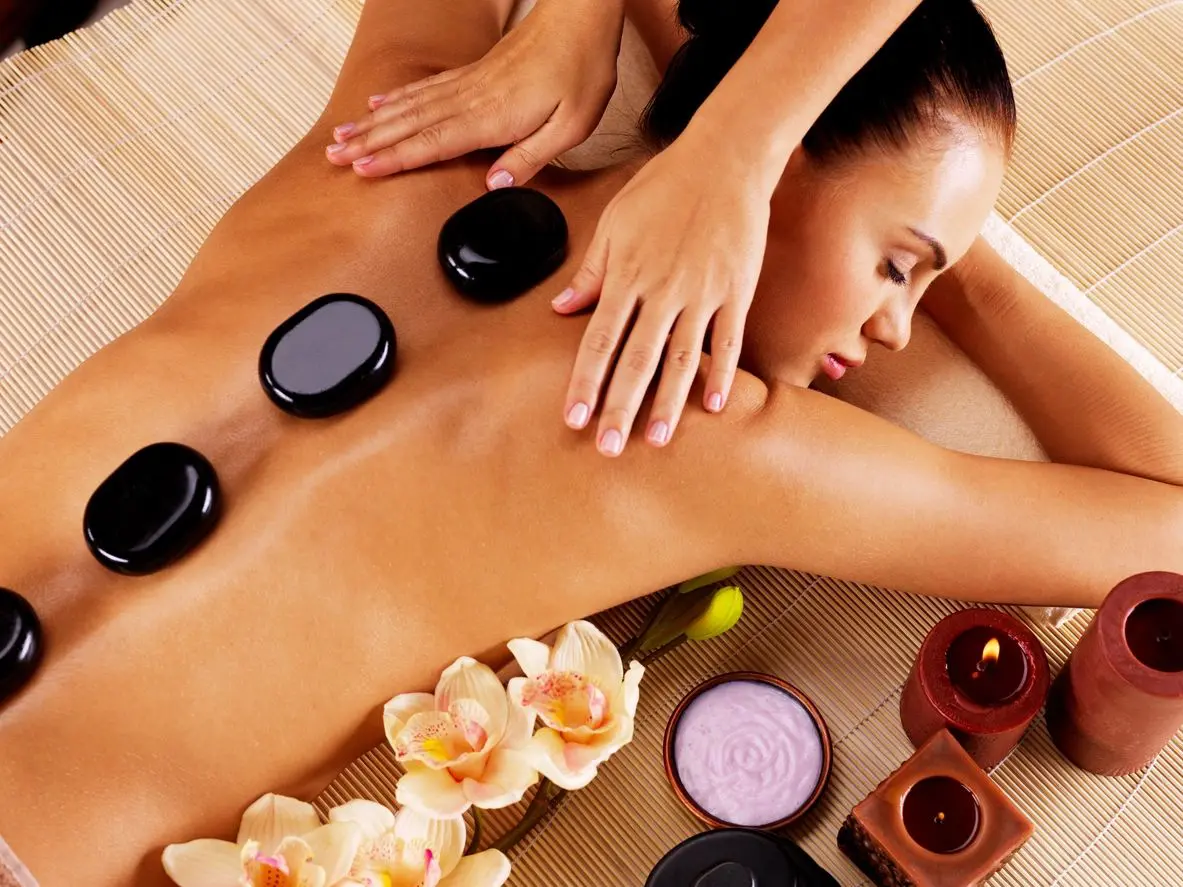 A woman getting her back turned to be massaged
